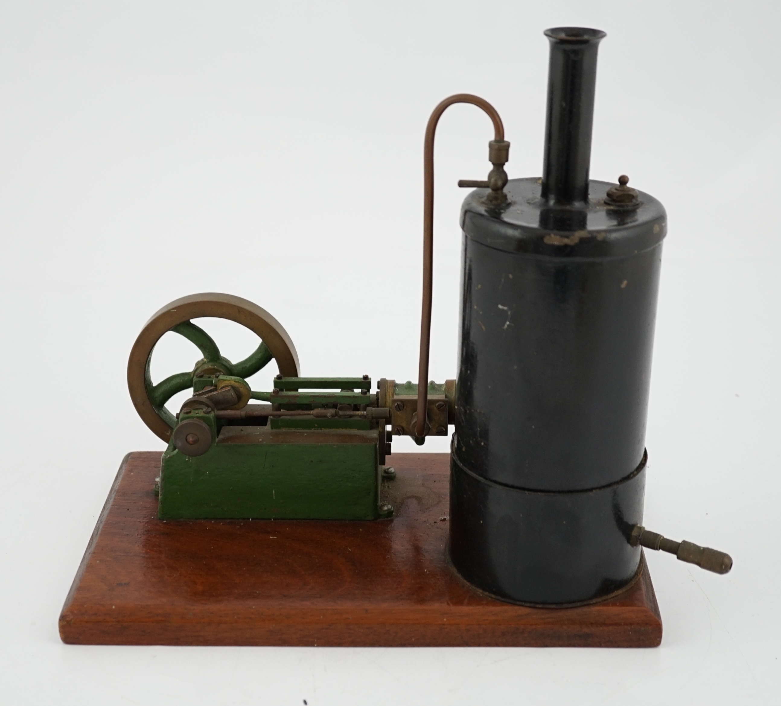 A Stuart Turner style stationary steam plant, with vertical boiler with fittings for a water sight glass and a pressure gauge (both missing), connected to a single cylinder horizontal steam engine with slide valve, mount